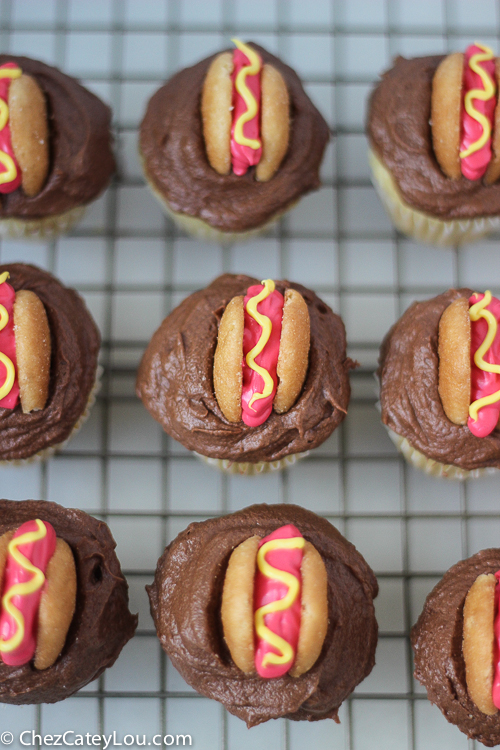 Mini Hot Dog Cupcakes - yellow cupcakes are topped with chocolate frosting and then decorated with a hot dog!  | ChezCateyLou.com