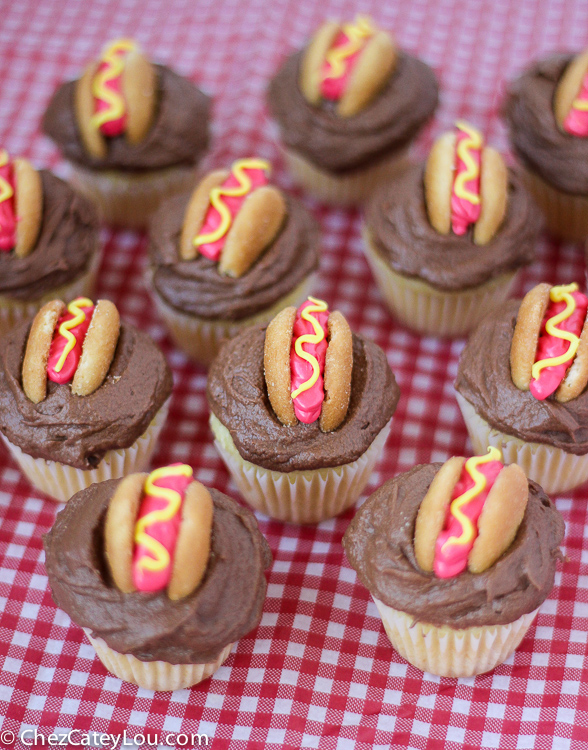 Mini Hot Dog Cupcakes - yellow cupcakes are topped with chocolate frosting and then decorated with a hot dog!  | ChezCateyLou.com