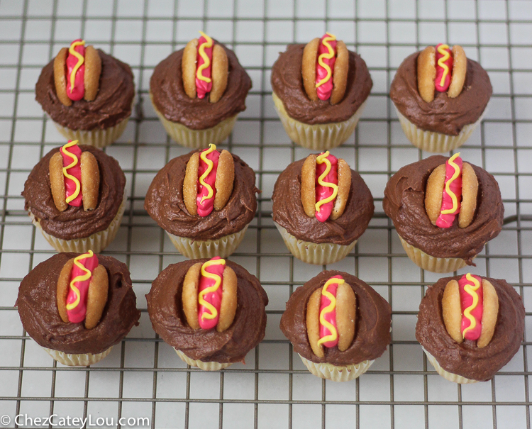 Mini Hot Dog Cupcakes - yellow cupcakes are topped with chocolate frosting and then decorated with a hot dog!  | ChezCateyLou.com