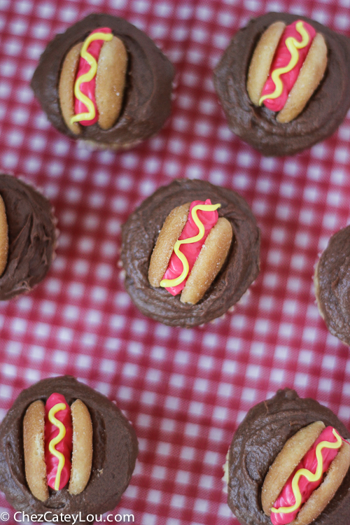 Mini Hot Dog Cupcakes - yellow cupcakes are topped with chocolate frosting and then decorated with a hot dog!  | ChezCateyLou.com