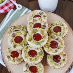 Pistachio Wreath Cookies - festive Linzer cookies decorated to look like a Christmas wreath! | ChezCateyLou.com