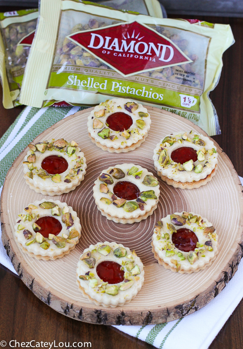 Pistachio Wreath Cookies - festive Linzer cookies decorated to look like a Christmas wreath! | ChezCateyLou.com